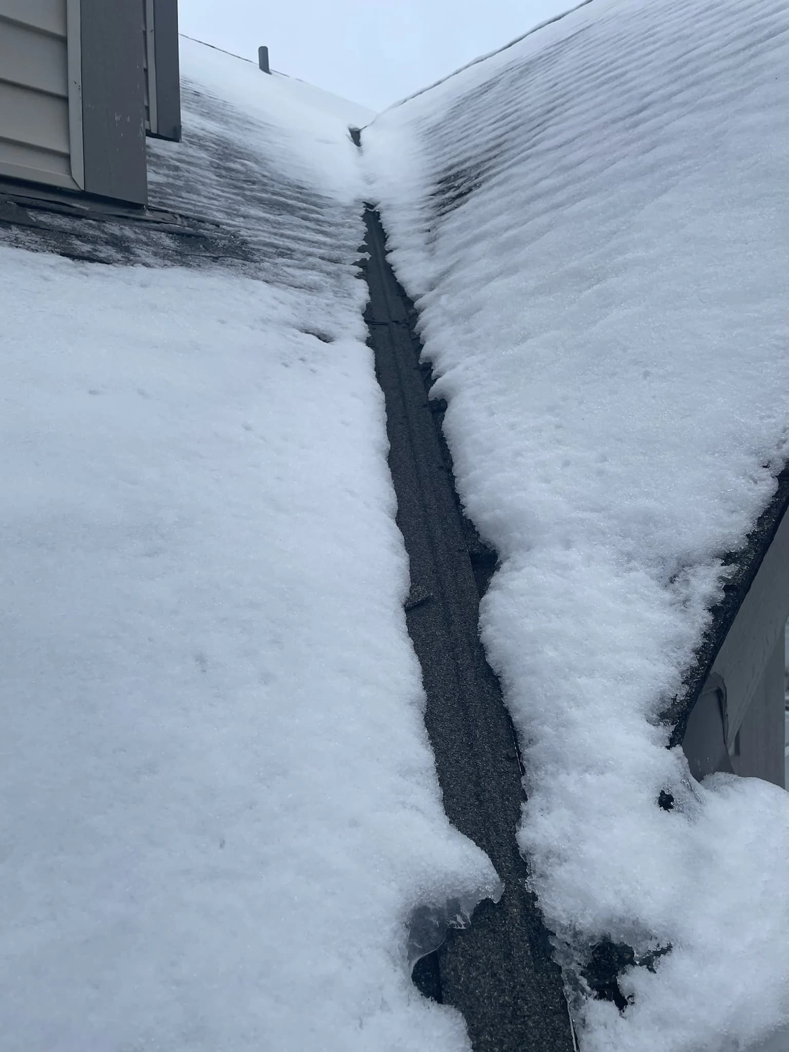 Heated gutter system preventing ice dam formation